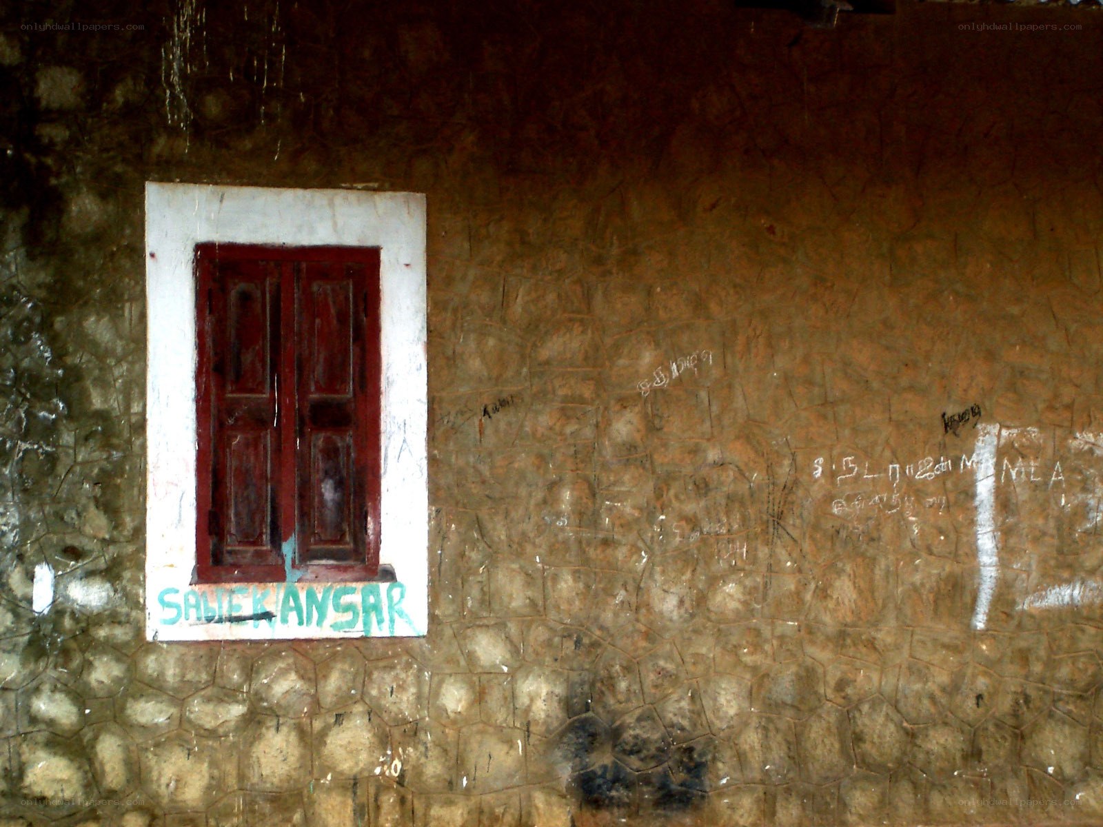 Weathered wall with red window