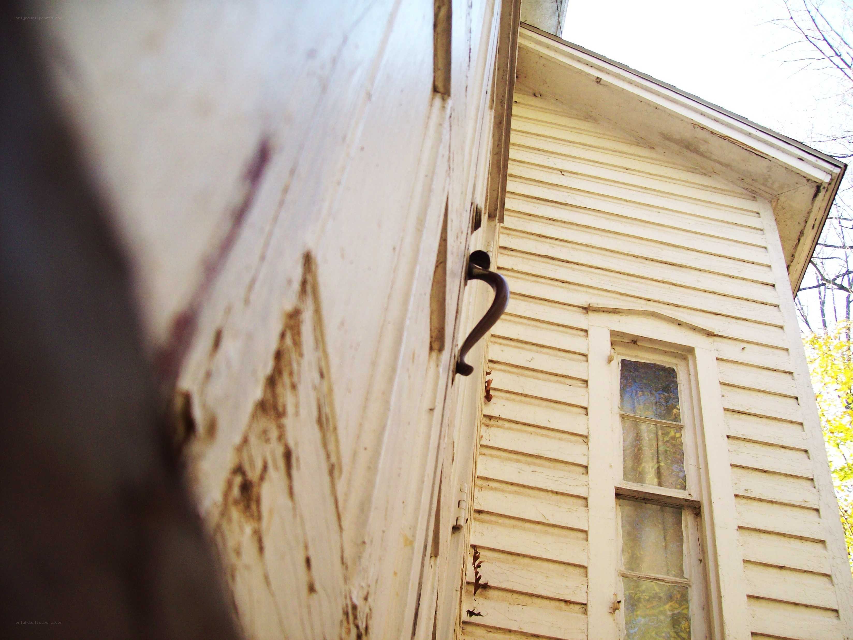 weathered white house exterior
