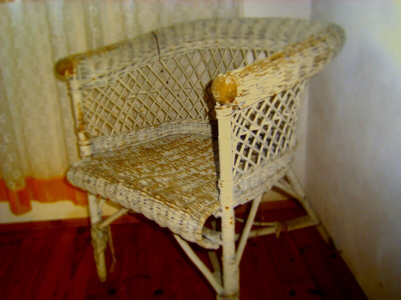 weathered wicker armchair