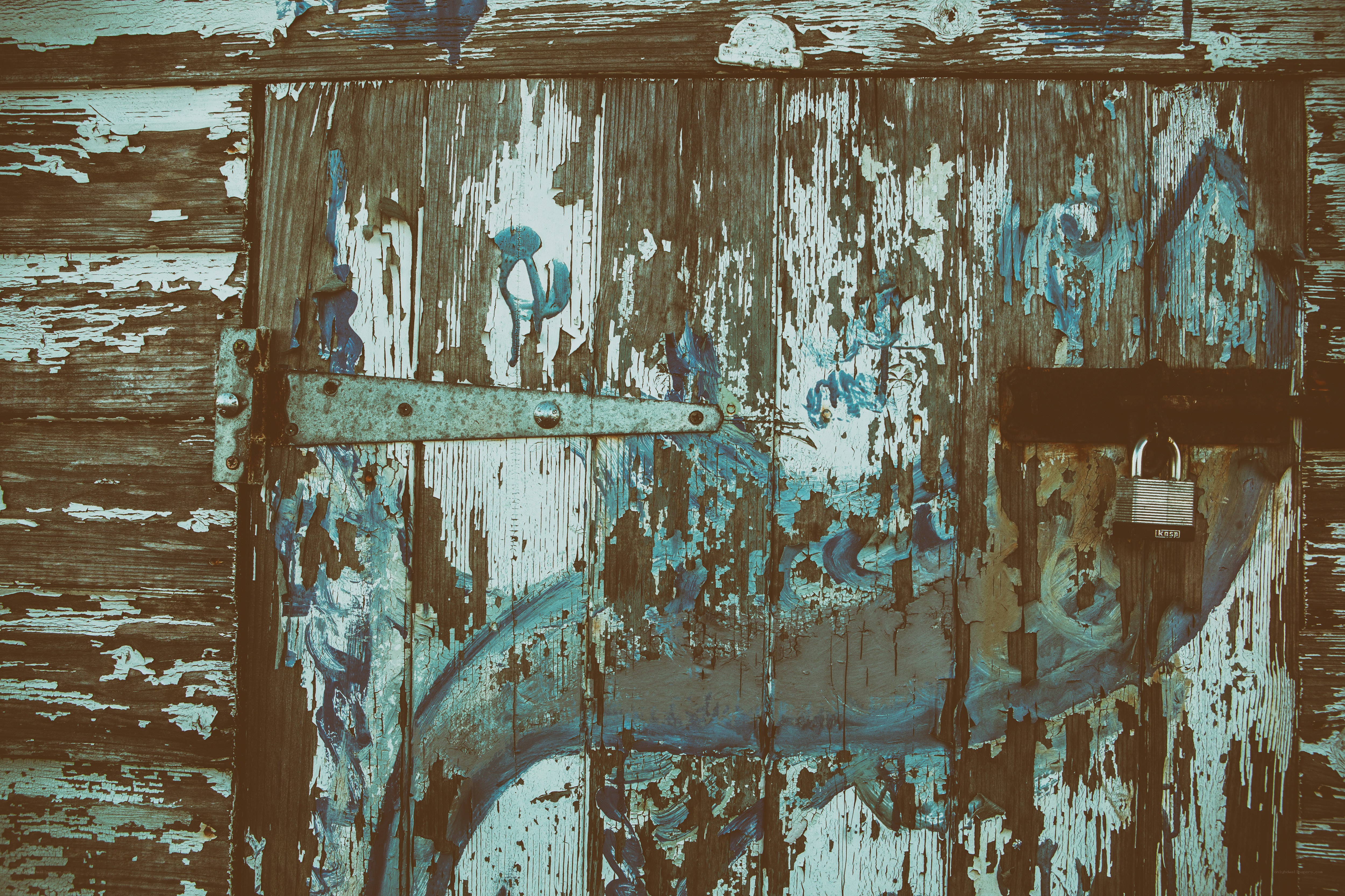 weathered wooden door with padlock
