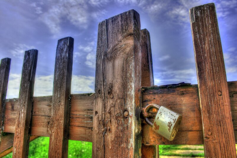 Weathered wooden gate with padlock