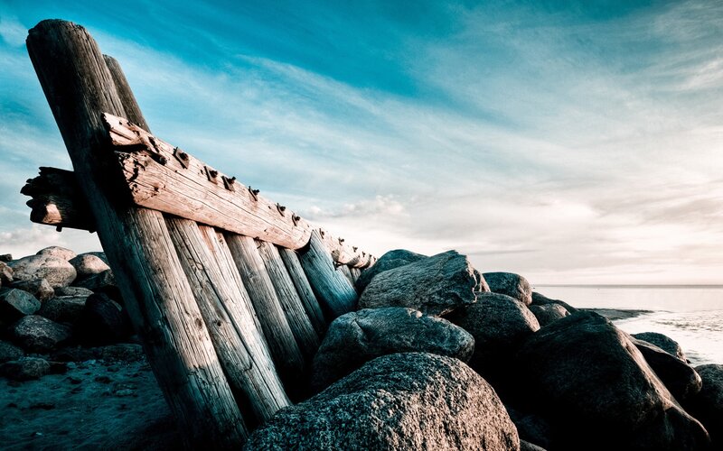 Weathered wooden structure on a rocky shore