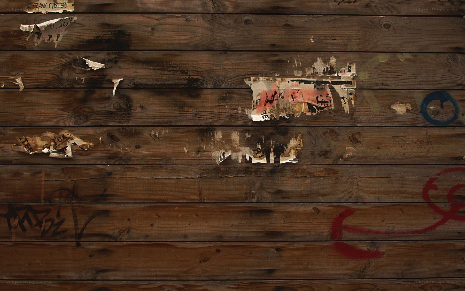 weathered wooden wall with graffiti