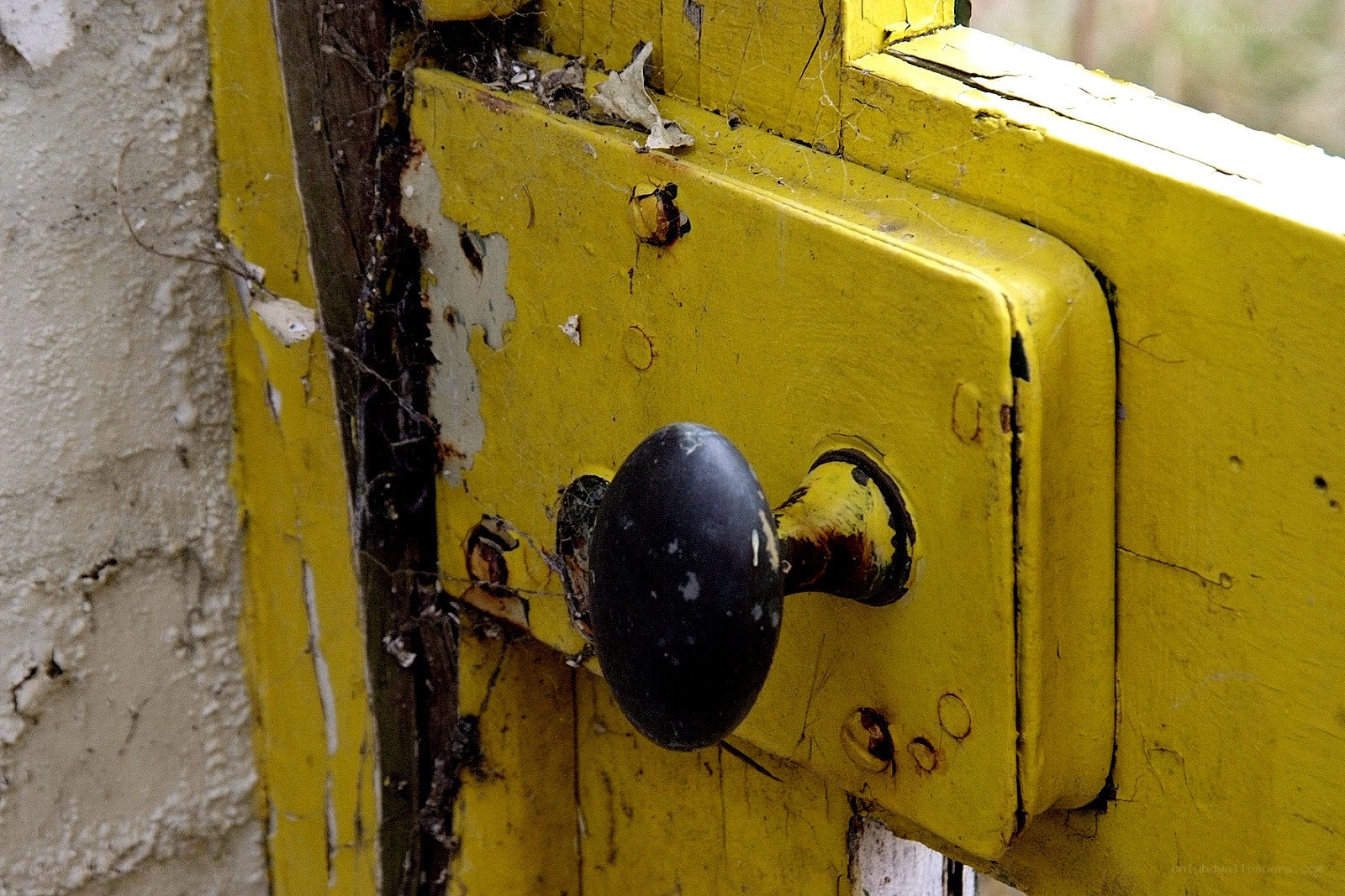 weathered yellow door handle