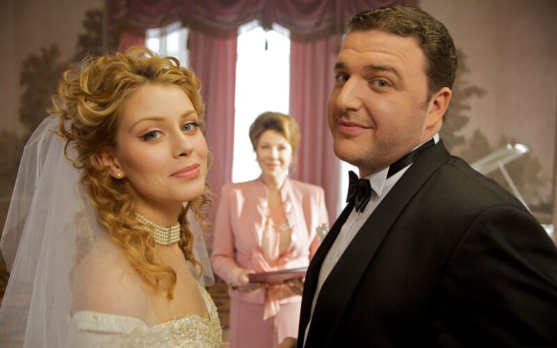 Wedding couple with mother in background
