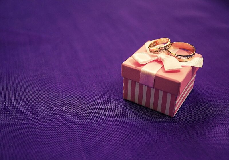 Wedding Rings on Gift Box — Purple