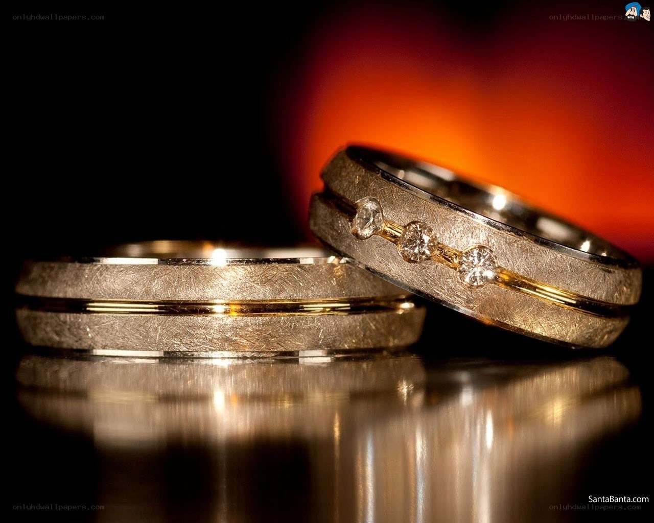 Wedding rings on reflective surface