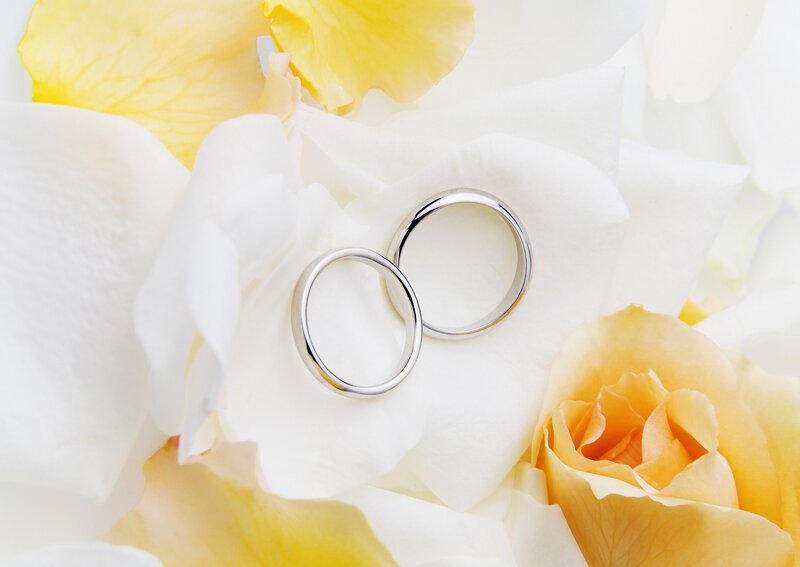wedding rings on rose petals