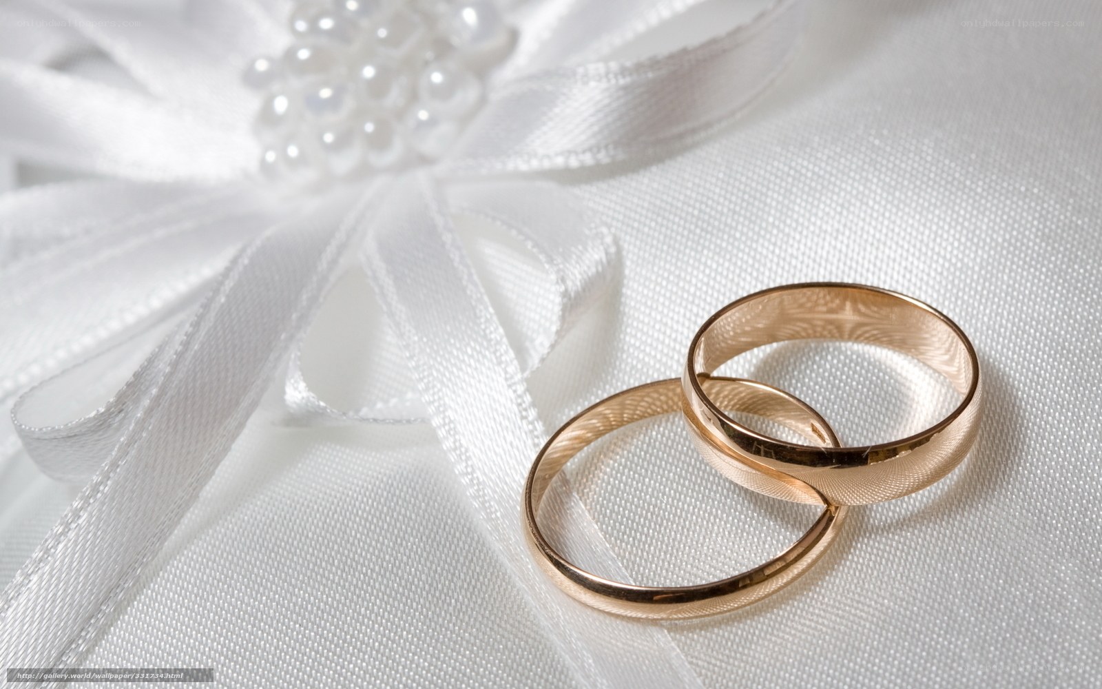 Wedding rings on white fabric