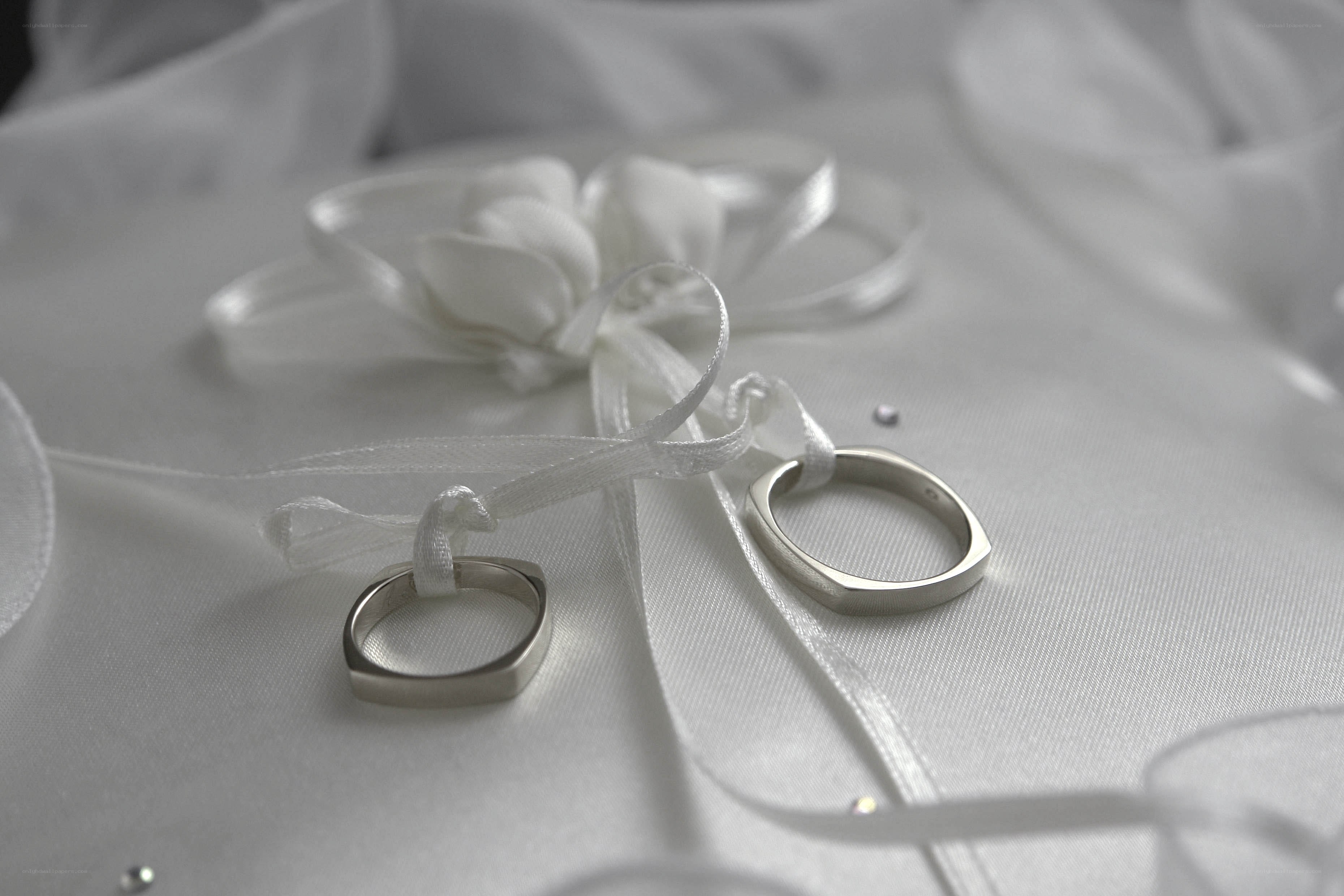 Wedding rings on white fabric