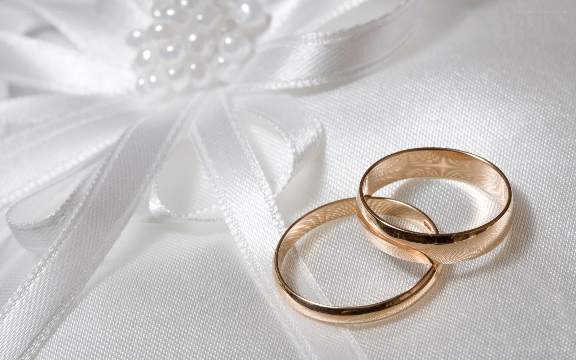 Wedding rings on white fabric