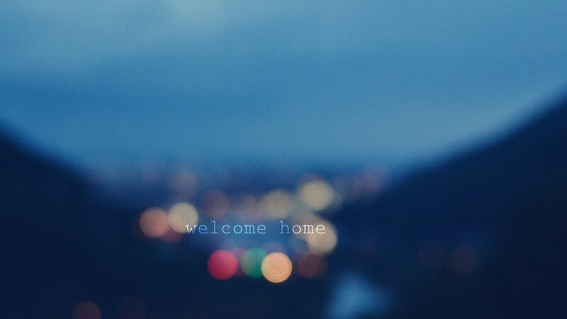 welcome home text over city lights