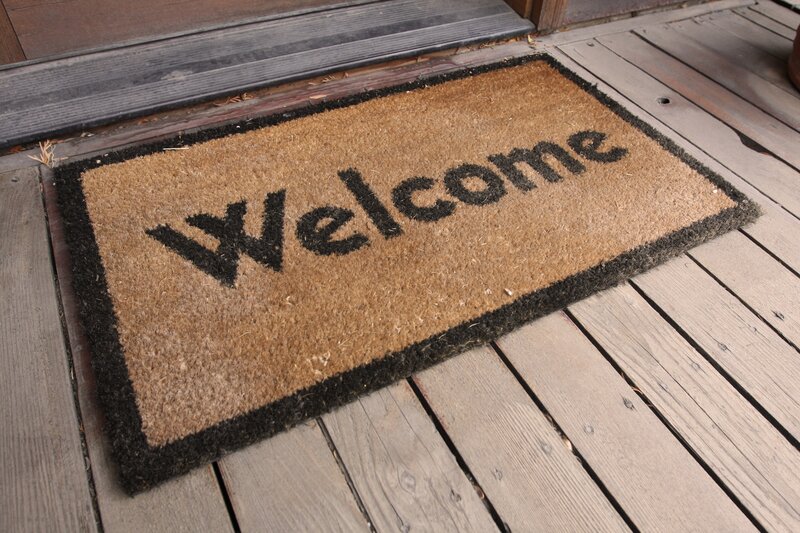 welcome mat on wooden deck