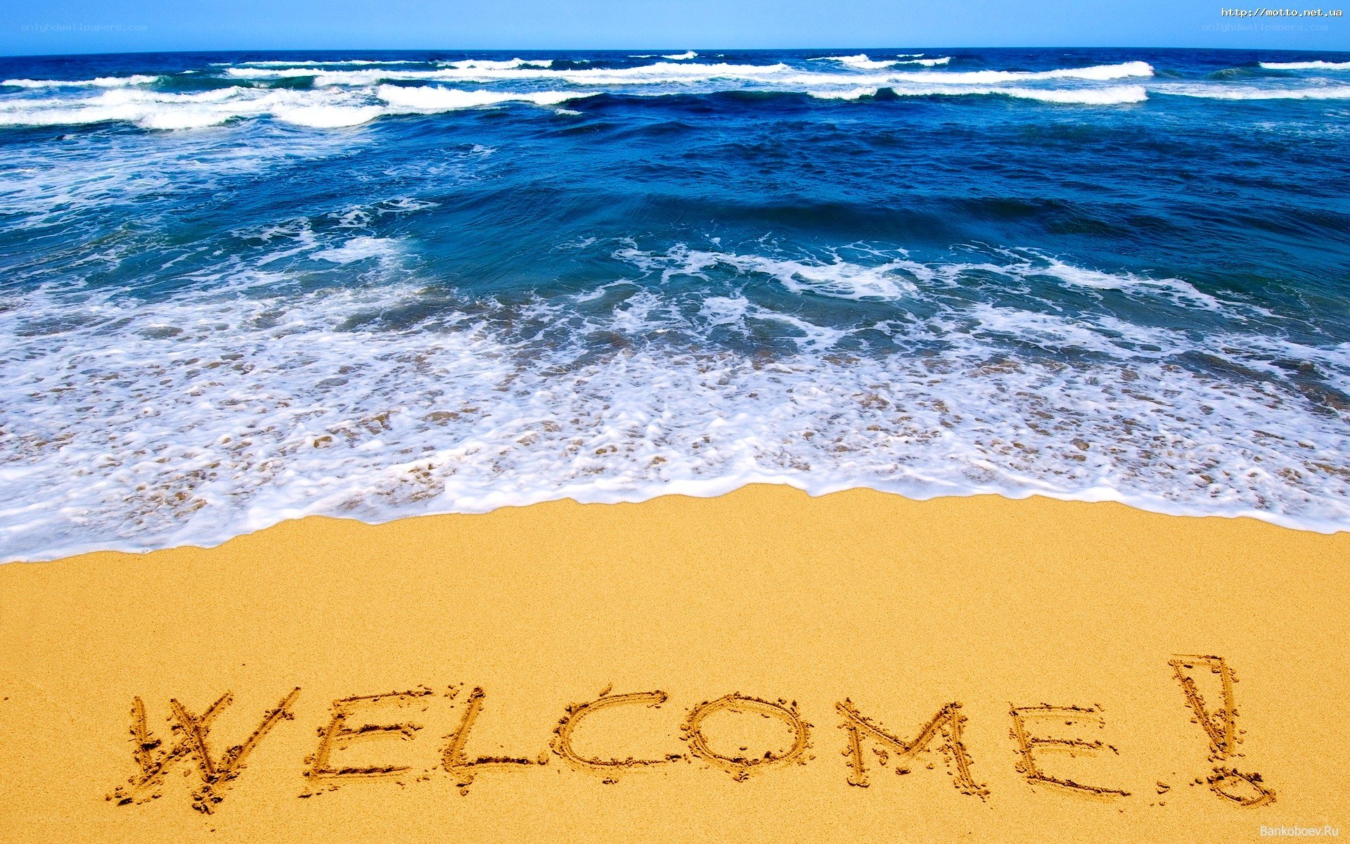 Welcome message on beach sand