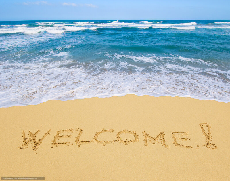 Welcome message on beach sand