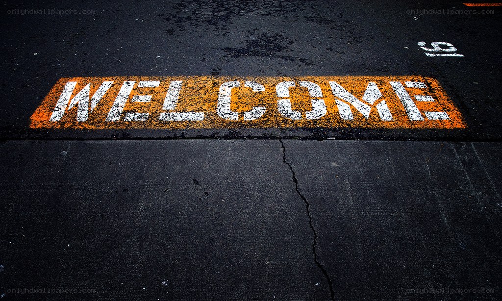 Welcome sign on asphalt