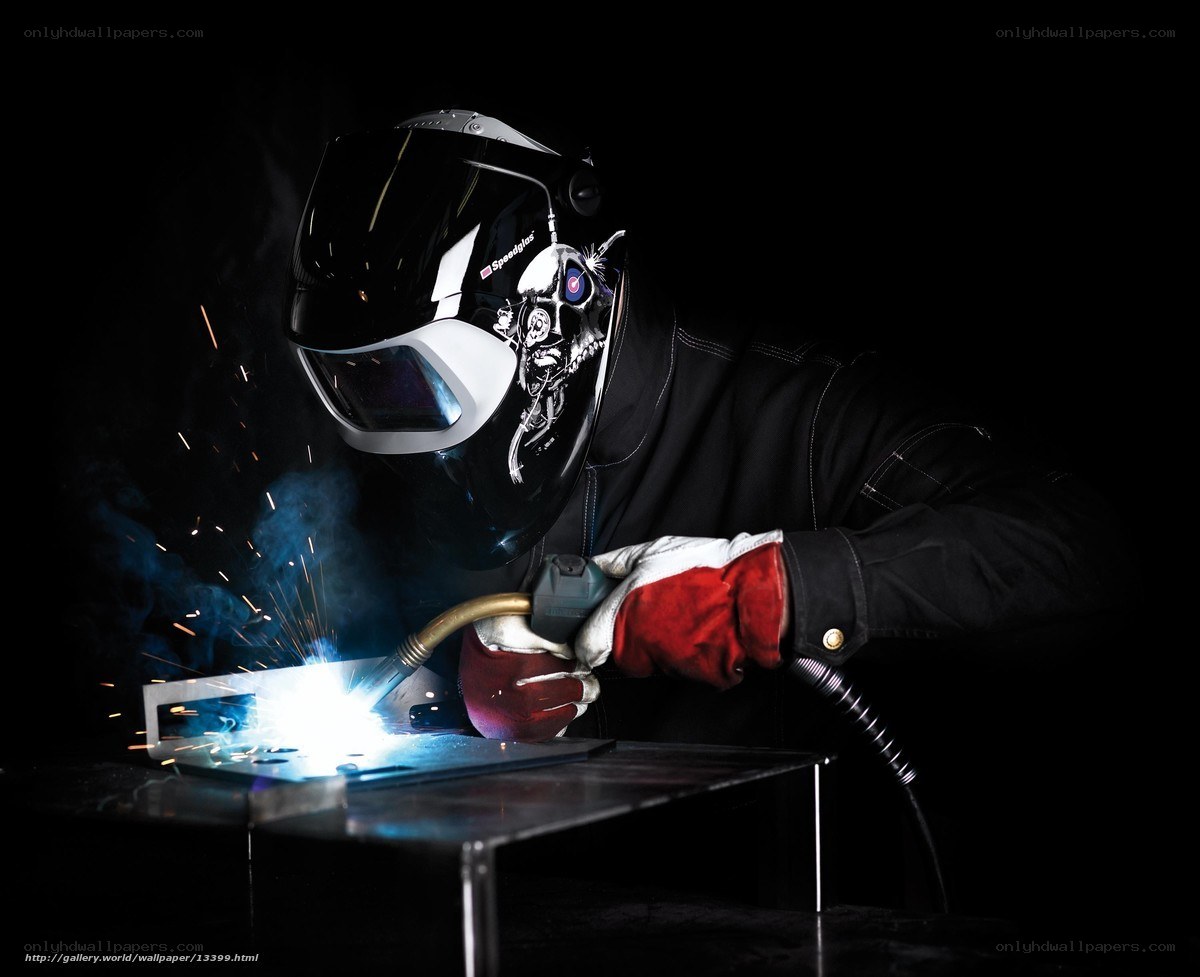 Welder at work with sparks