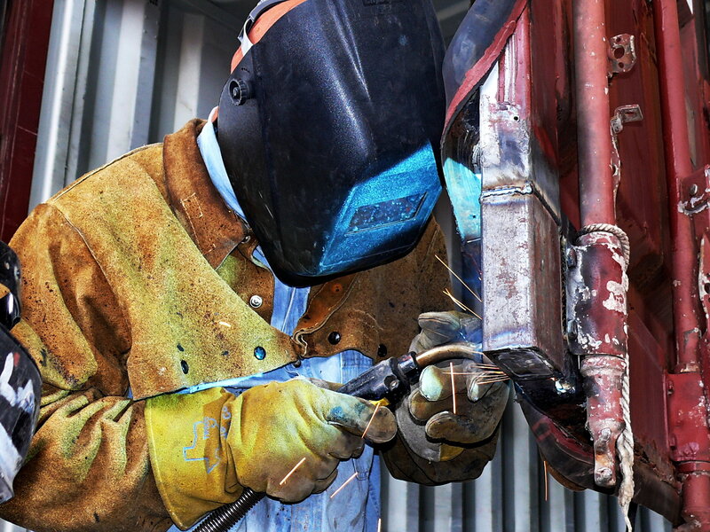 Welder working on metal structure