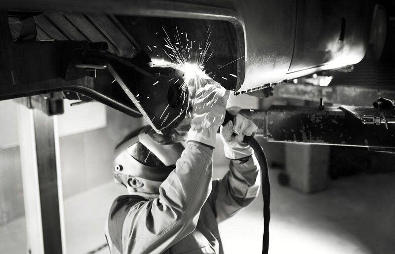 Welder working on vehicle