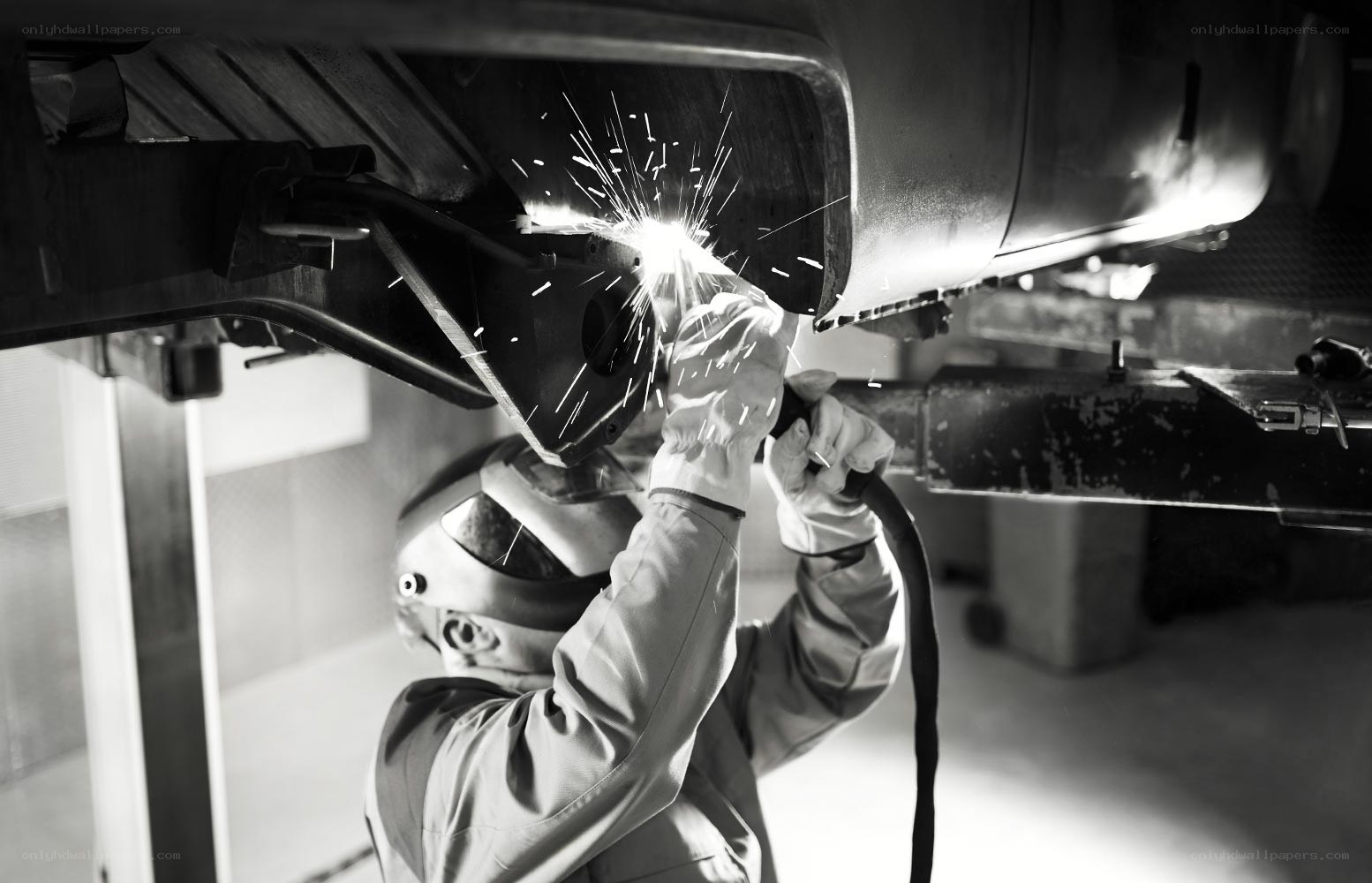 Welder working on vehicle