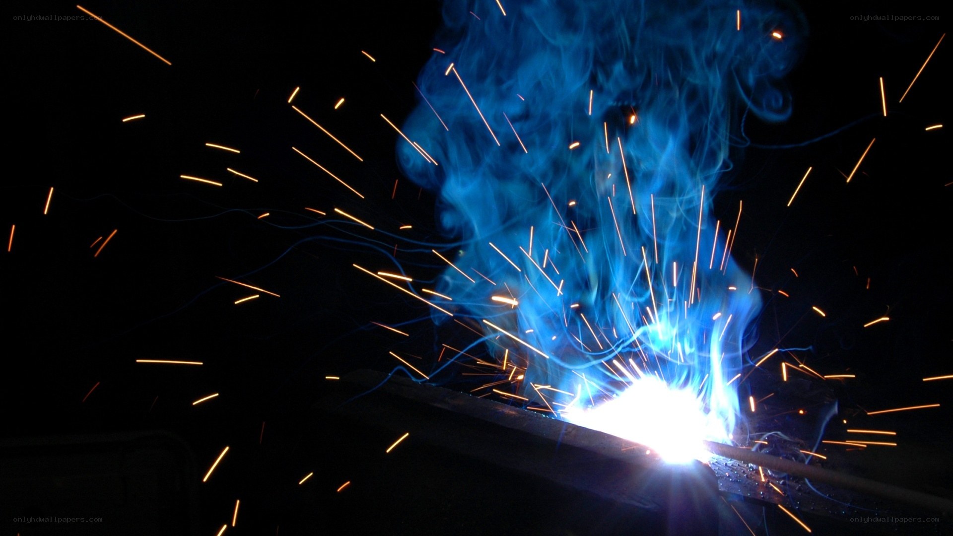 Welding sparks and blue flame