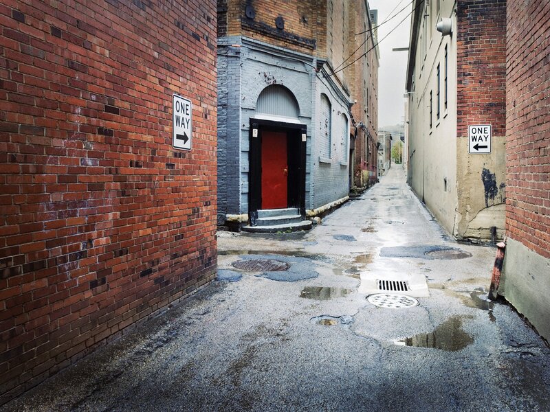 wet alley with one-way signs