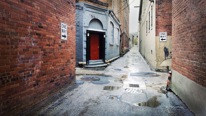Wet alley with one-way signs