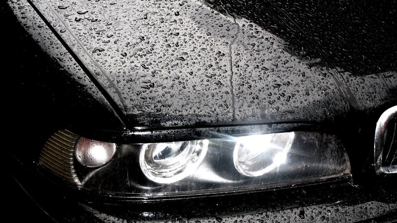 wet car headlight at night