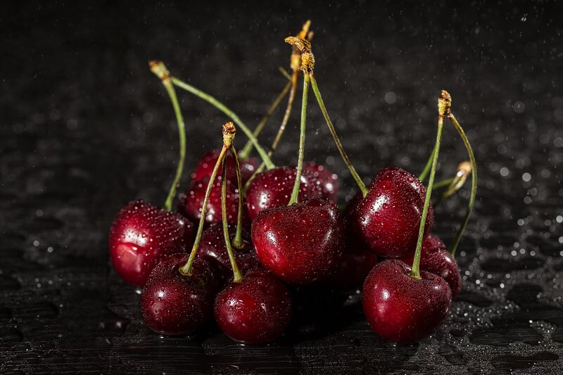 Wet Cherries on Dark Surface