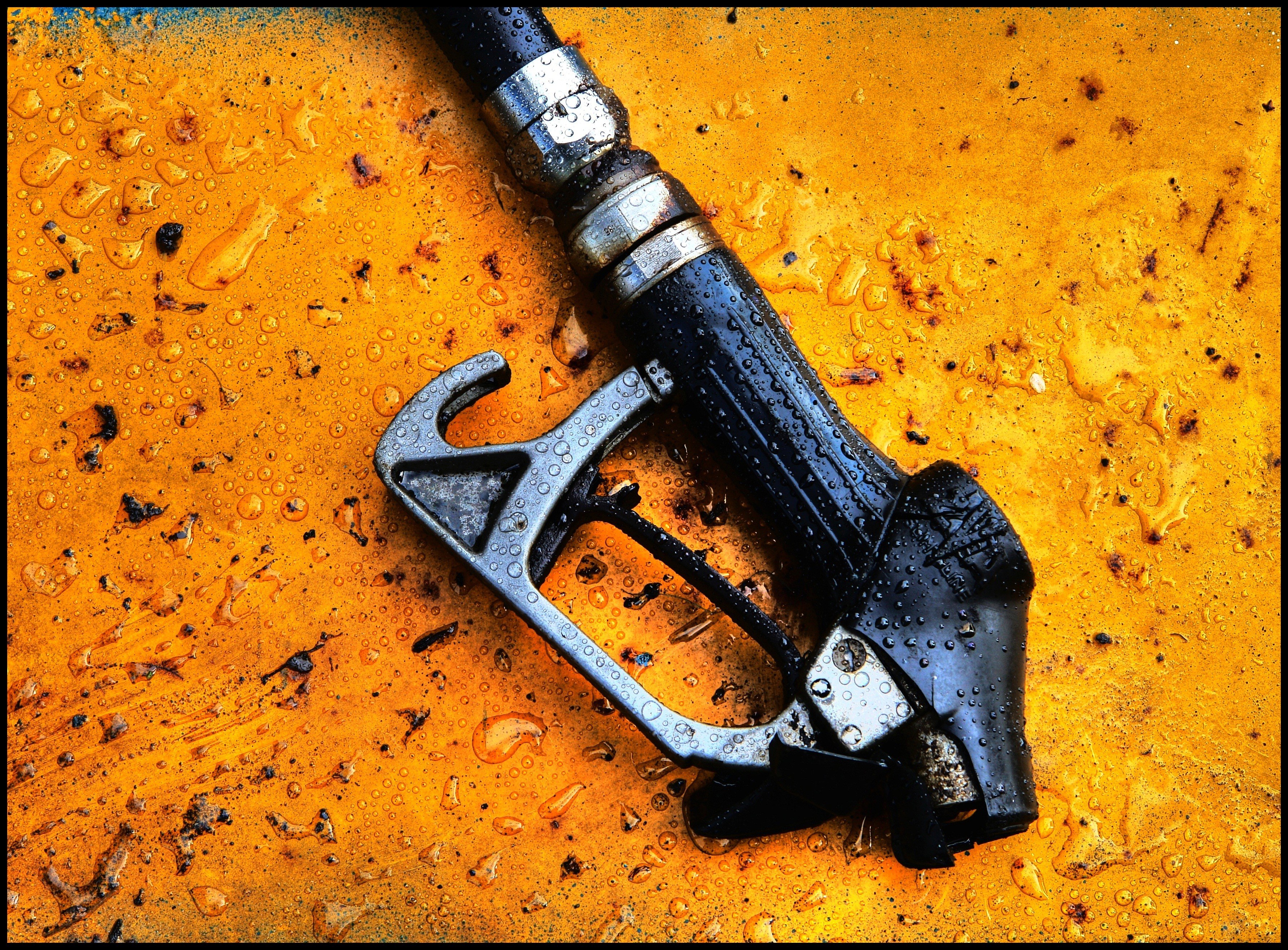 wet fuel nozzle on orange surface