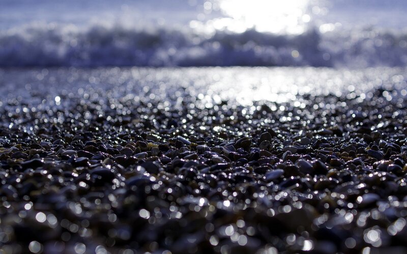 Wet Pebbles on Beach — Black