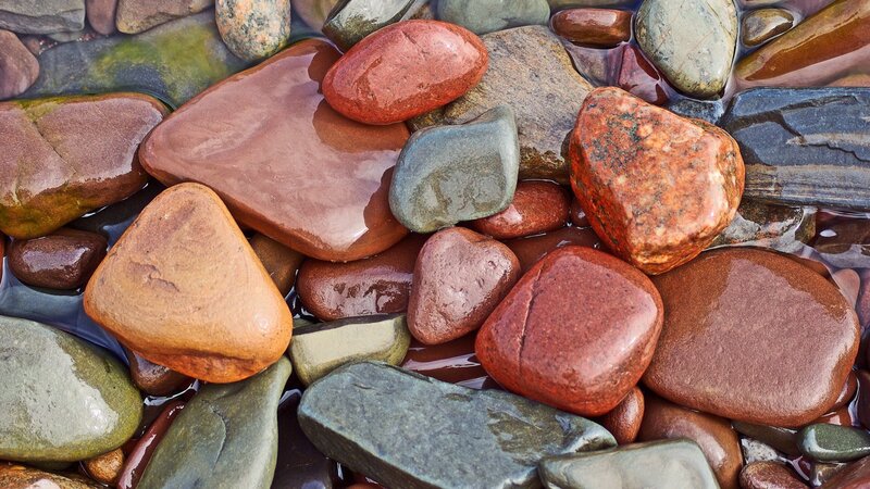 Wet river stones in shallow water