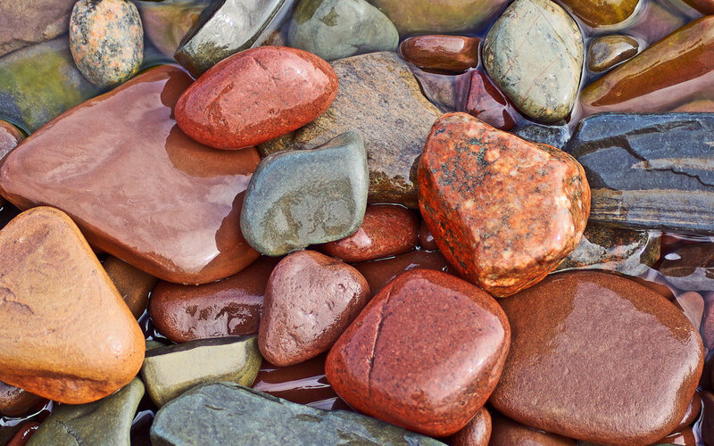 Wet river stones in shallow water
