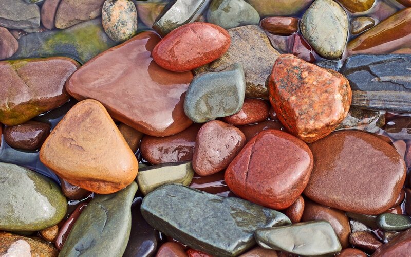 Wet river stones in shallow water