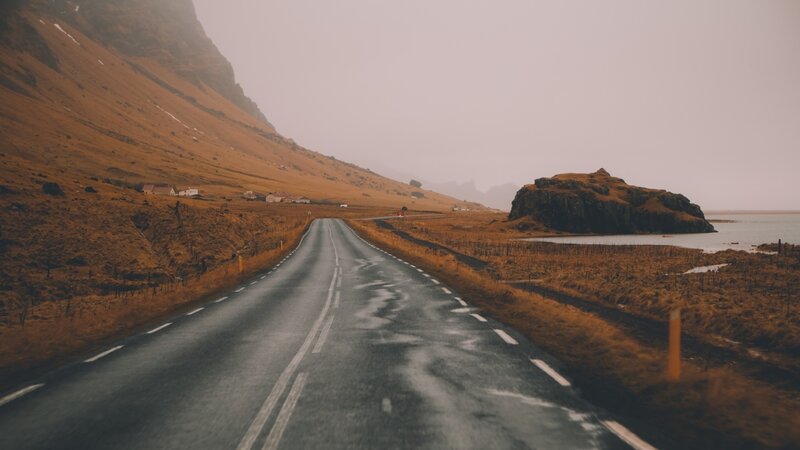 Wet Road in Mountain Valley — Brown