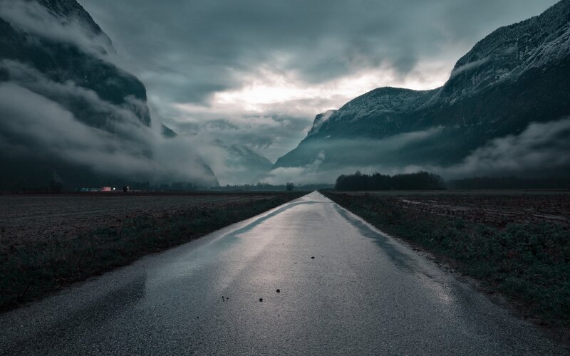Wet Road in Mountain Valley — Gray, Dramatic