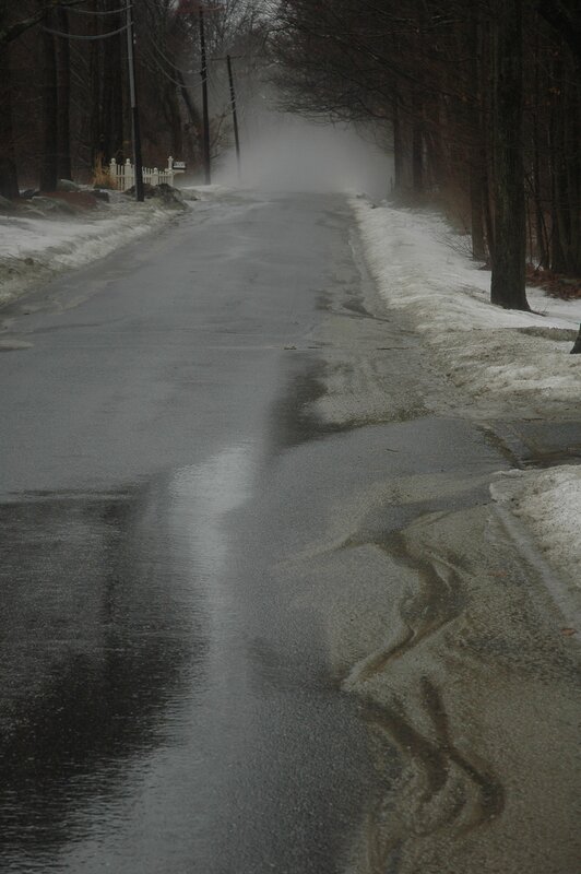 wet road in winter fog