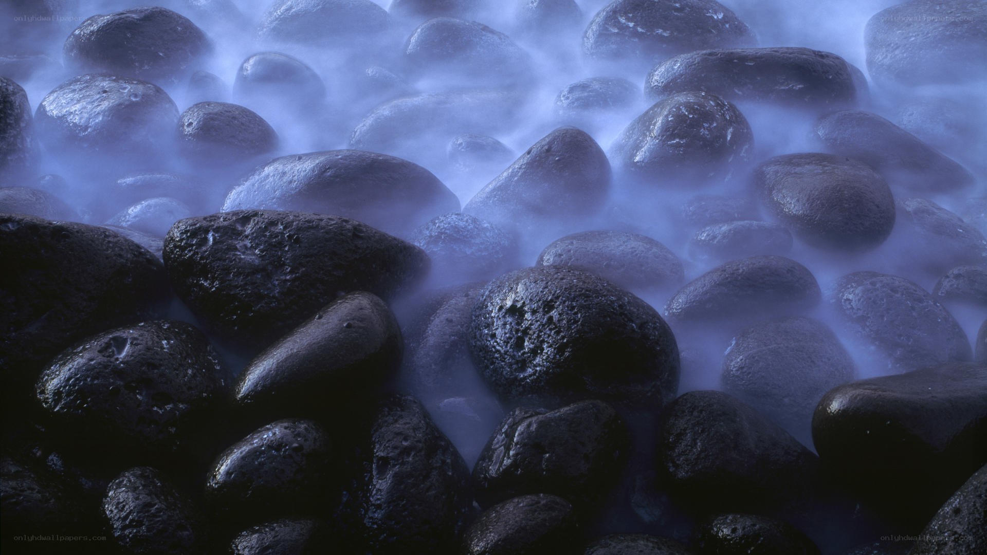 Wet rocks in misty water
