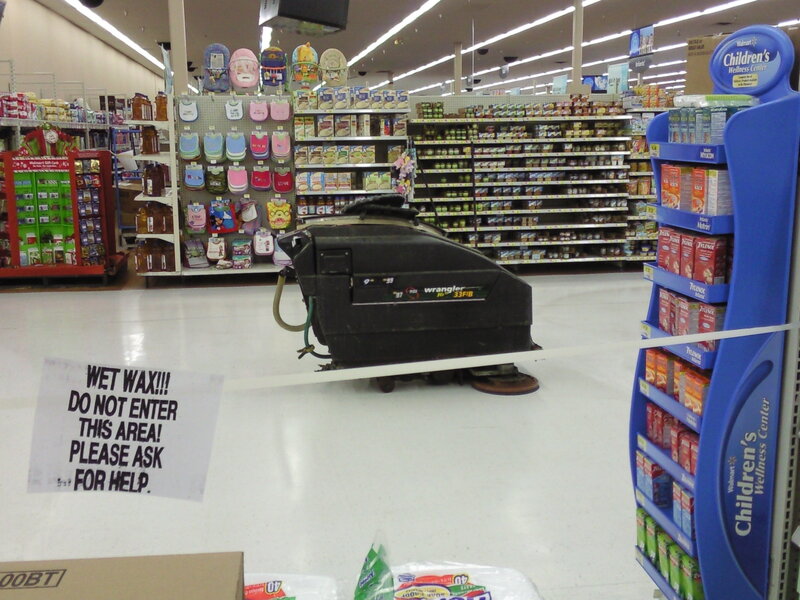 Wet wax sign in store aisle