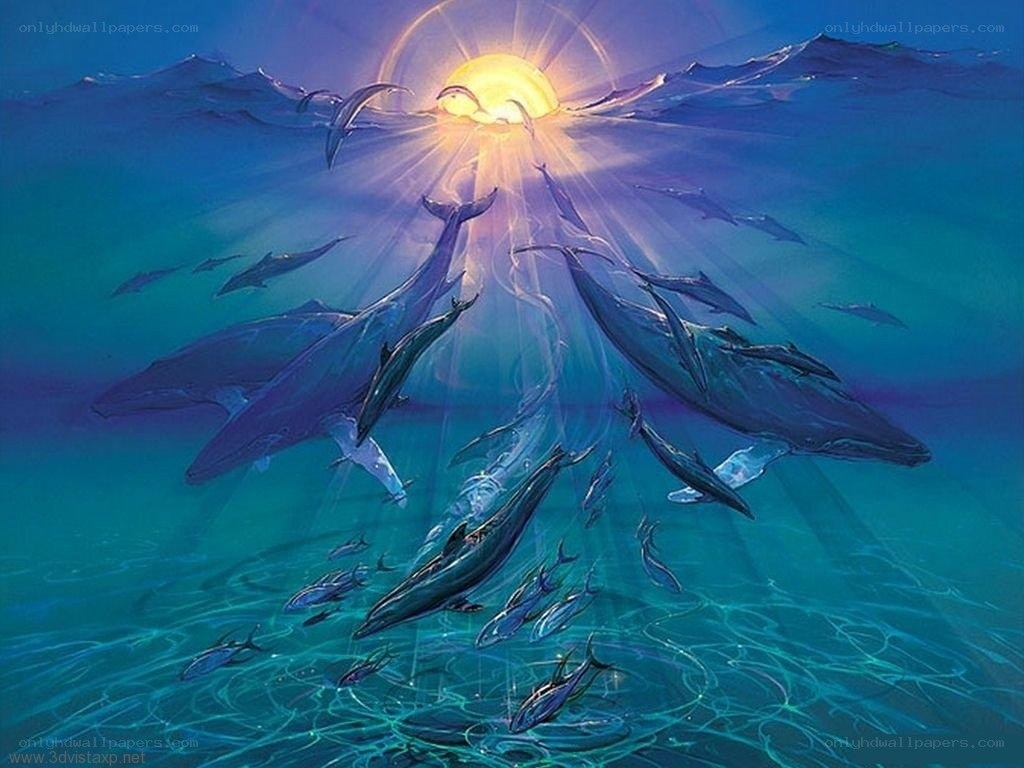 Whales swimming in sunlit ocean