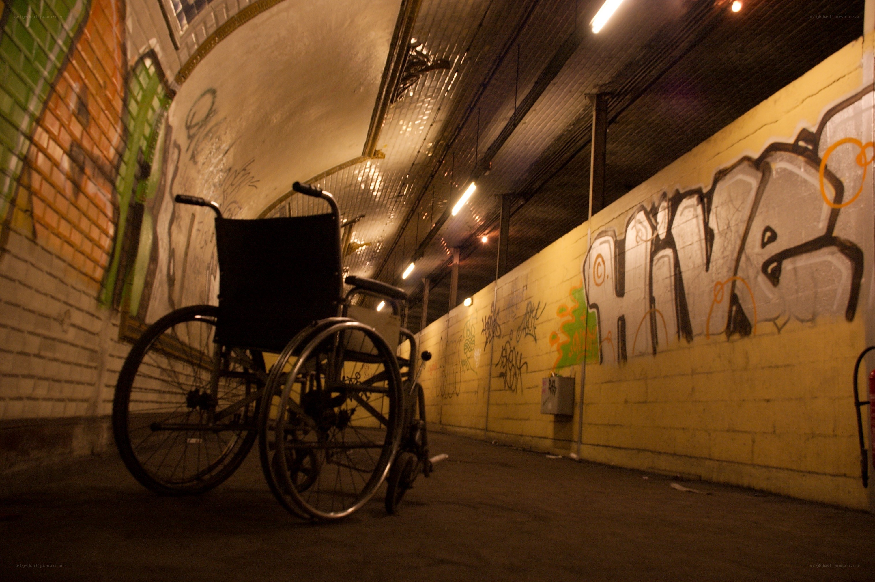 wheelchair in a graffiti tunnel
