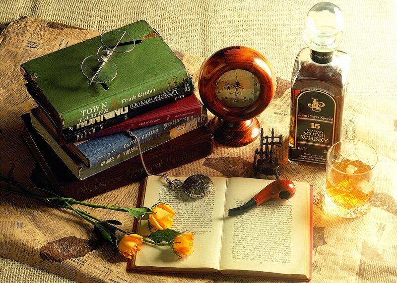 Whiskey and books on newspaper