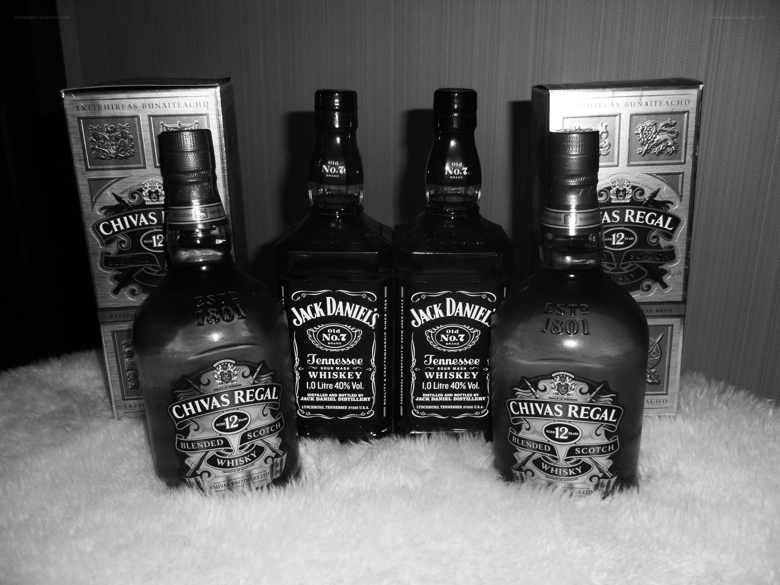 Whiskey bottles on white fur