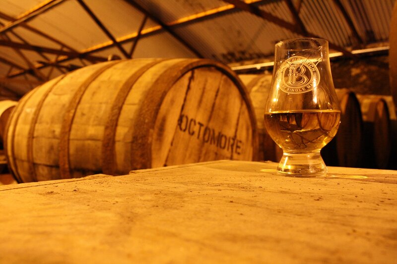 Whiskey glass in a barrel room