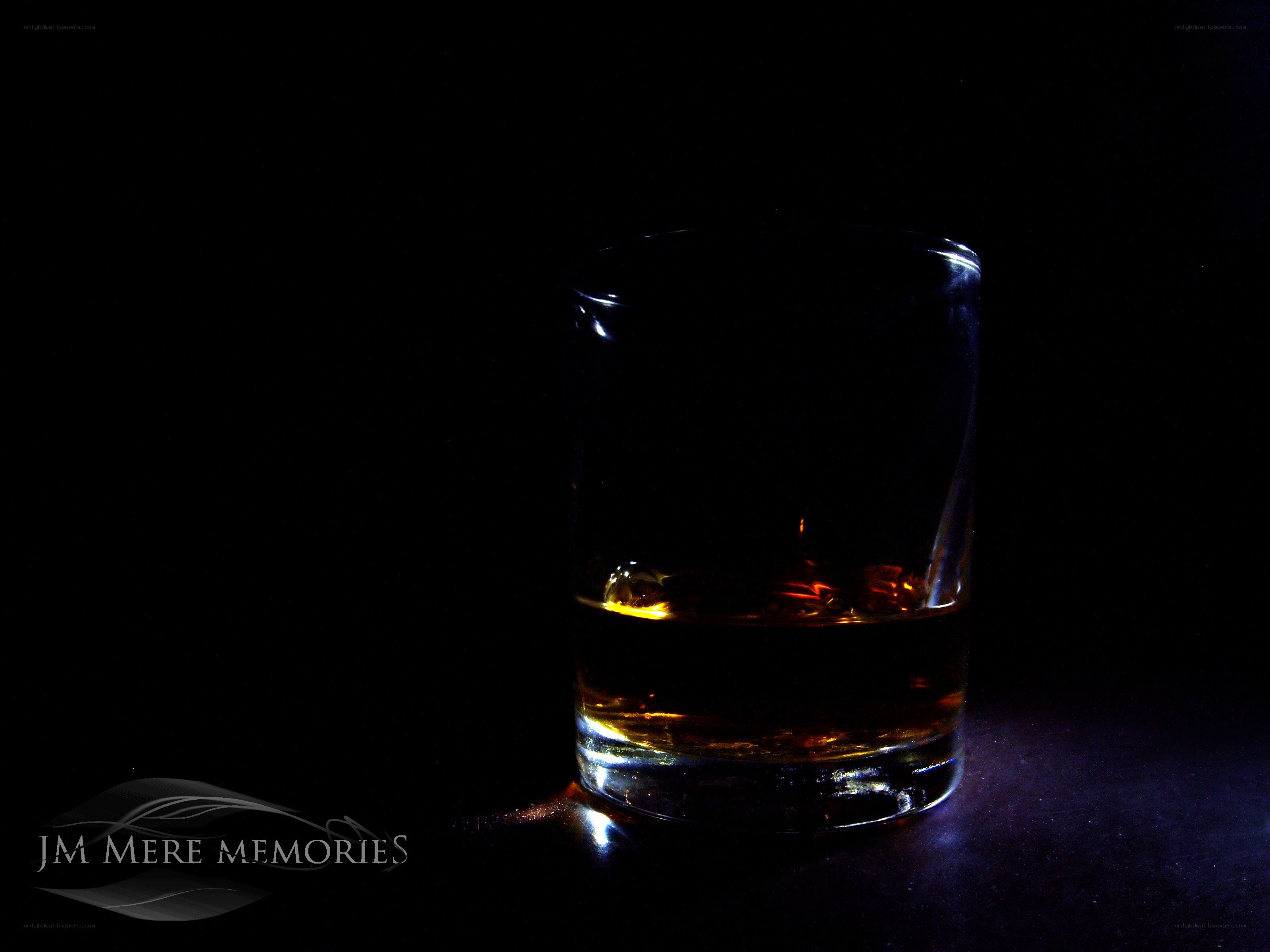 Whiskey glass in darkness