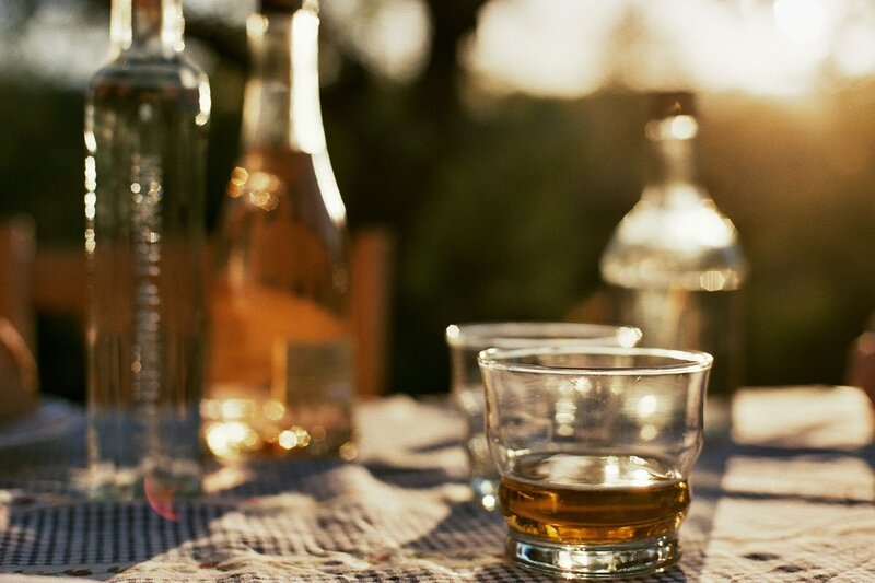 Whiskey on a table at sunset