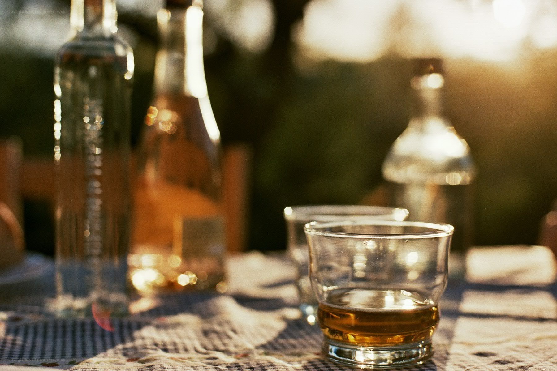 Whiskey on a table at sunset
