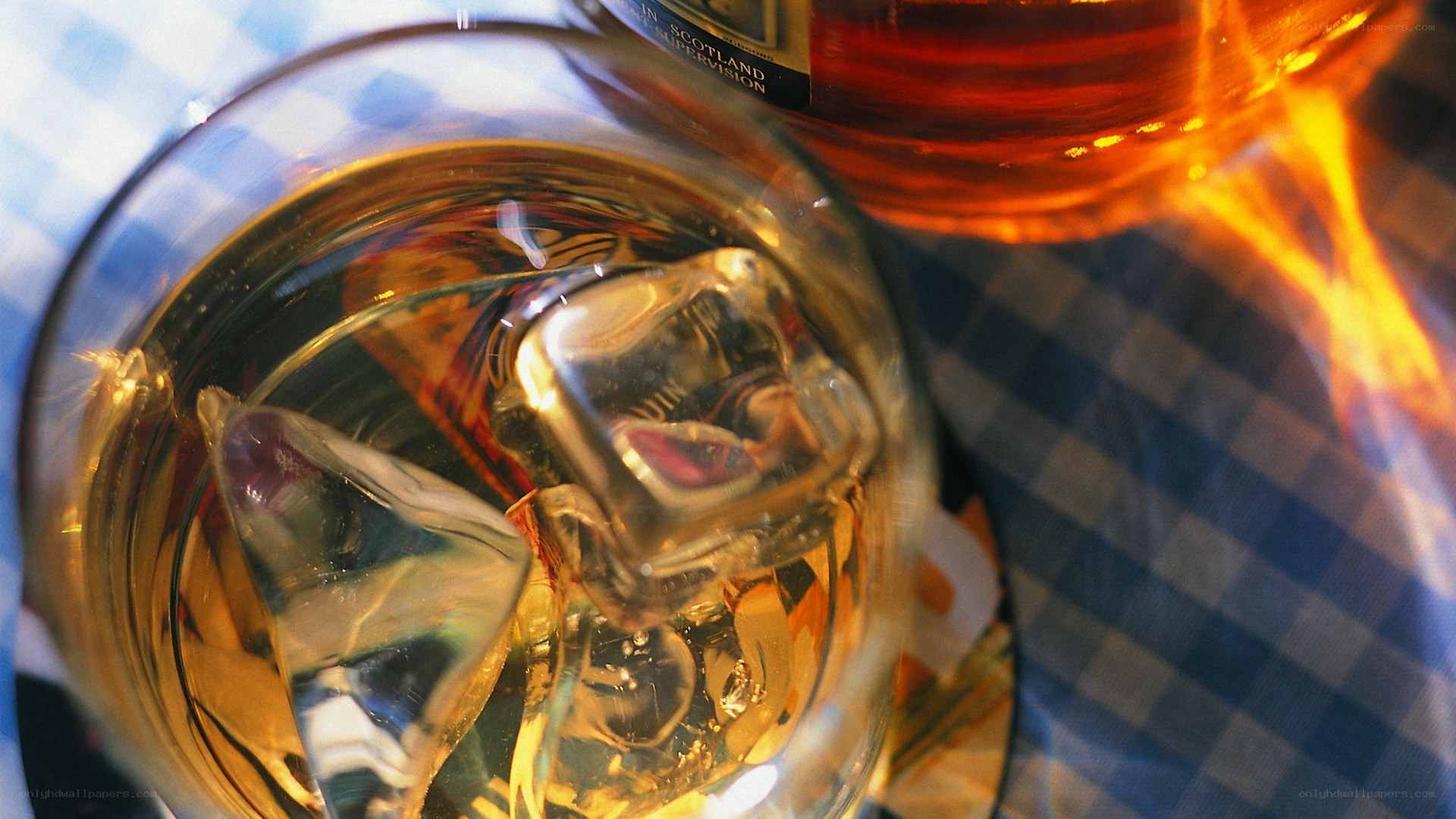 Whiskey with ice on checkered cloth