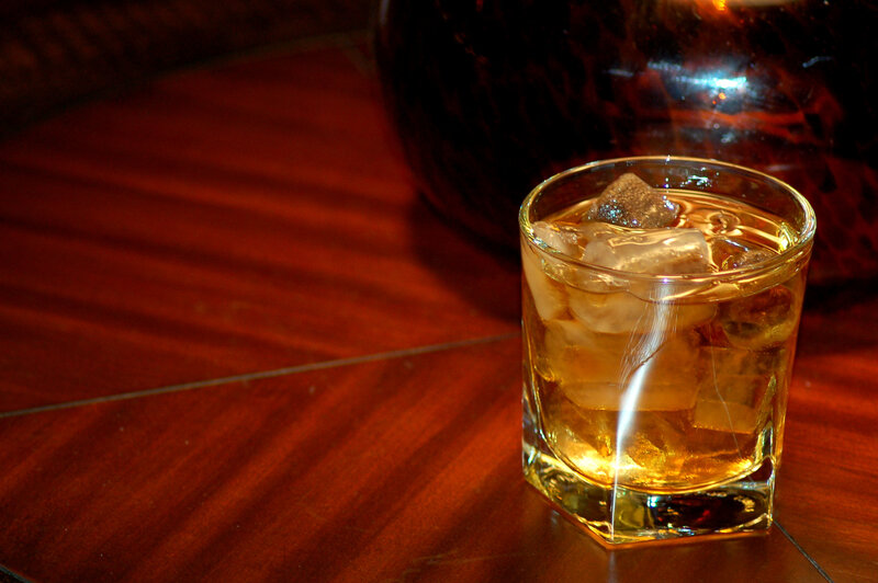 Whiskey with ice on wood