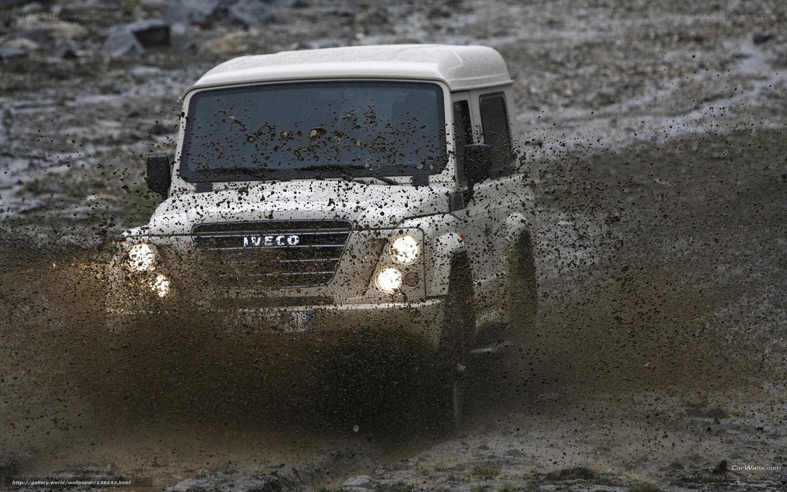 white 4x4 driving through mud